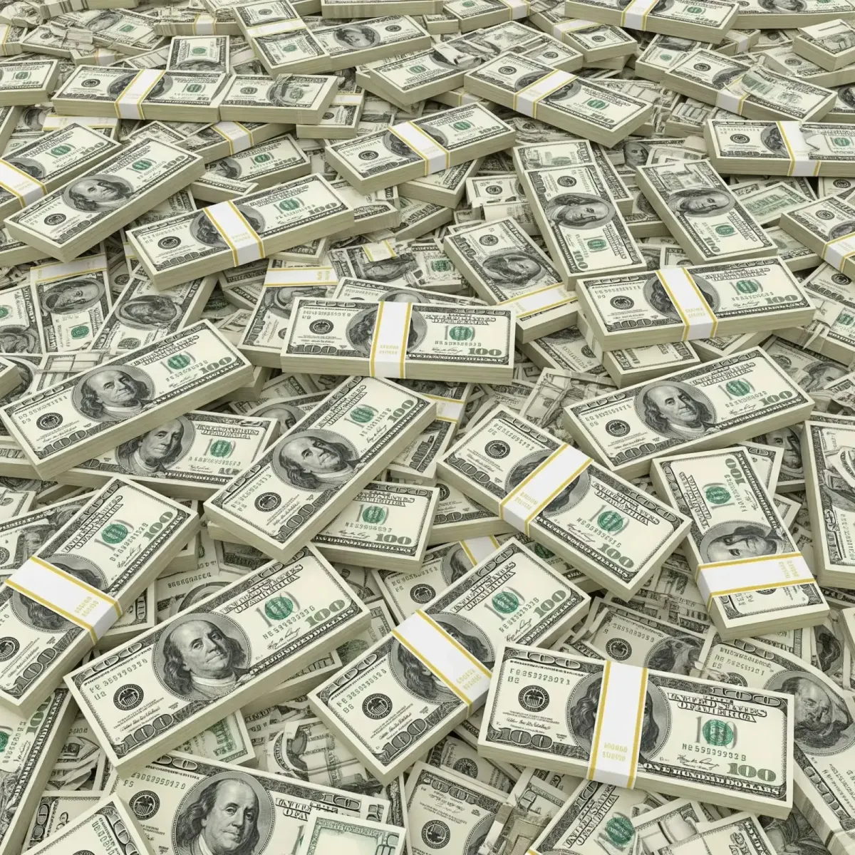 overhead view of scattered stacks of hundred-dollar bills