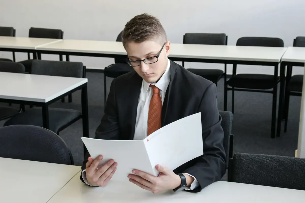 Guy in a suit reading 