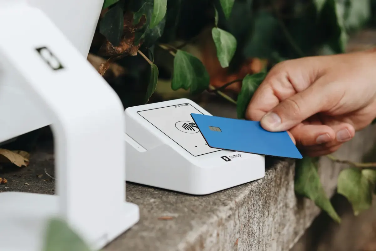 Hand fanning out credit cards including Capital One and Amex
