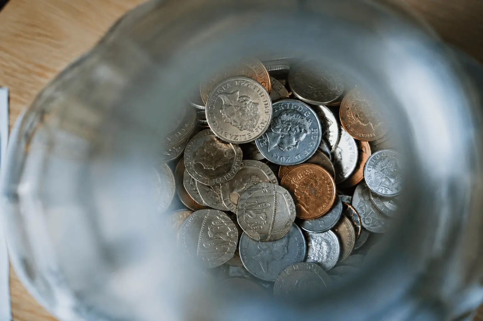 Jar filled with coins viewed from above
