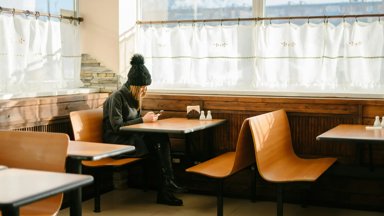 Girl sits inisde a fast food restaurant