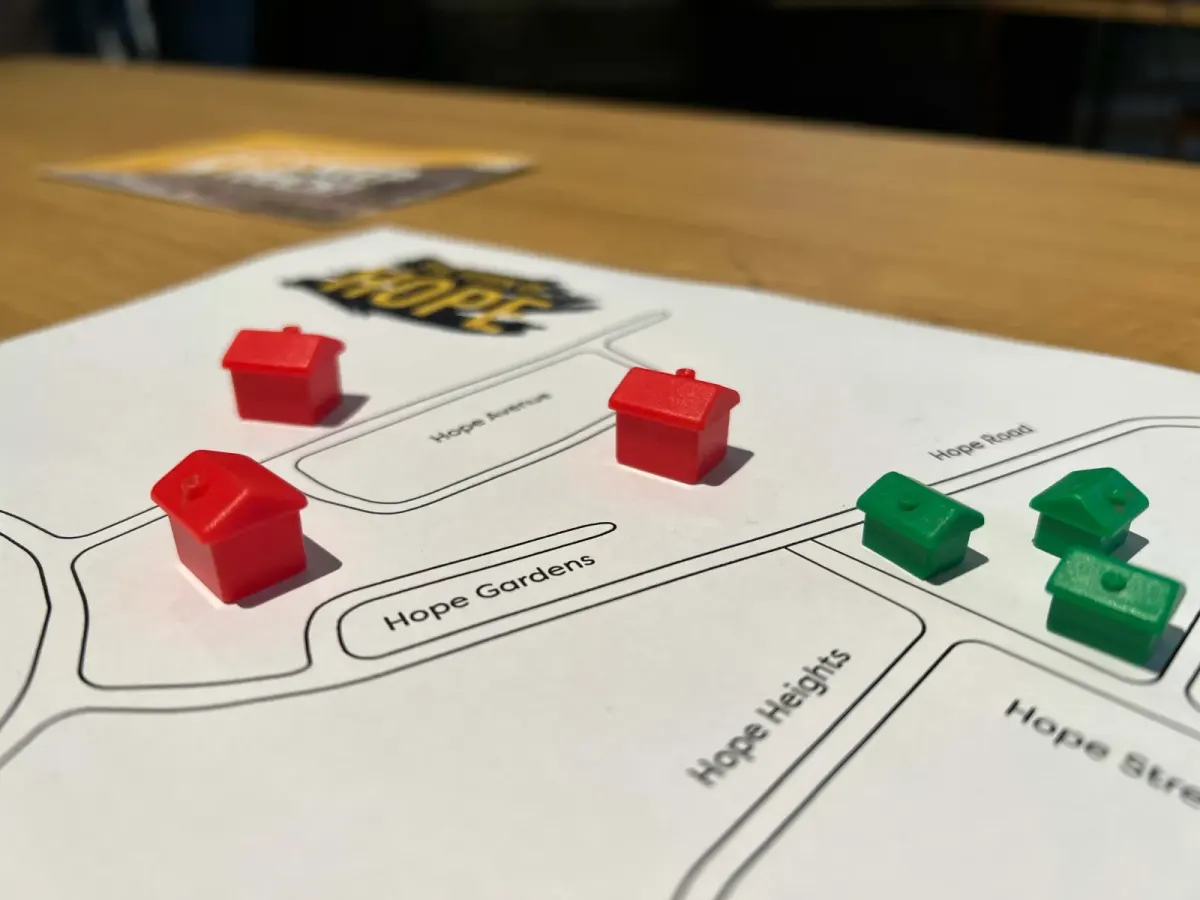 Toy houses arranged on a hand-drawn street map