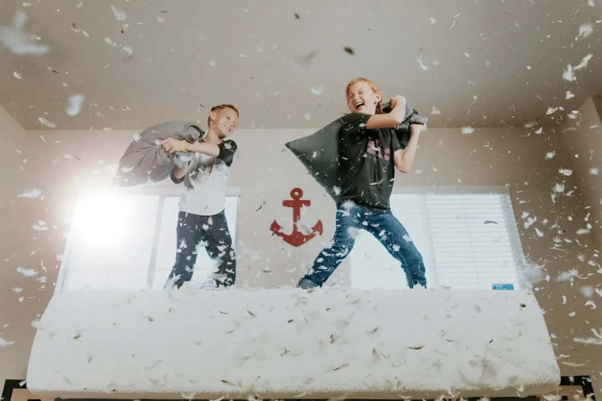 Two kids in a pillow fight