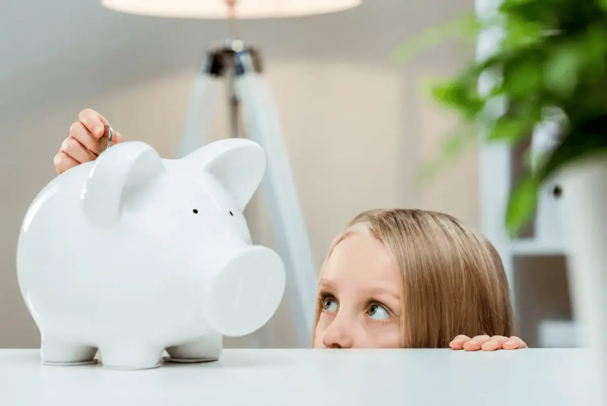 Kid using a piggy bank