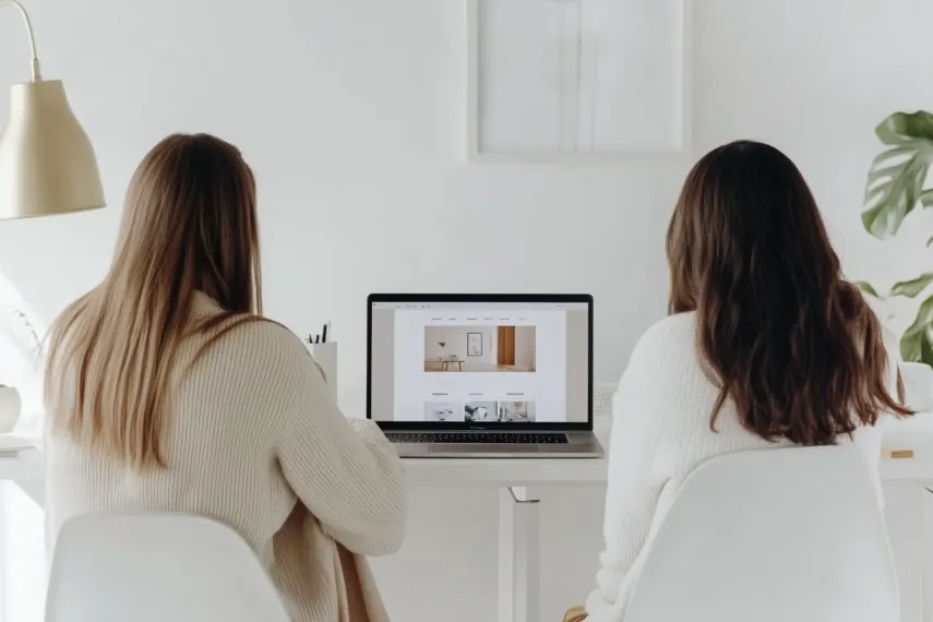 Two women sitting at a desk designing
