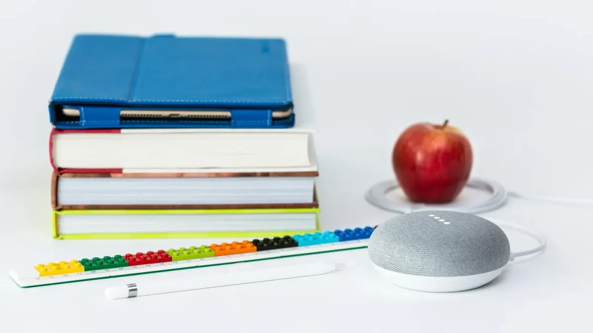 Books and an apple sitting in a desk