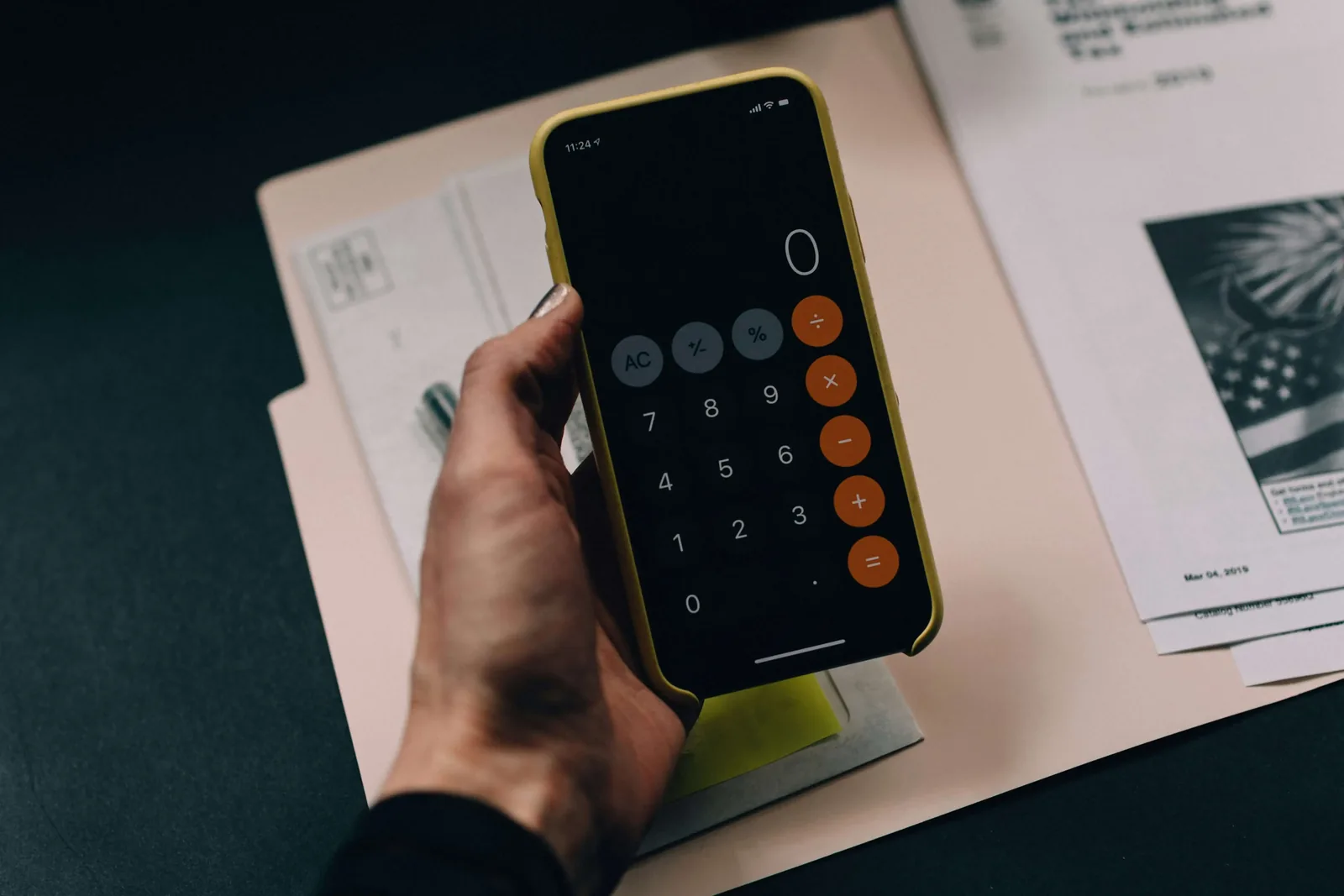 Hand holding a phone with a calculator app open
