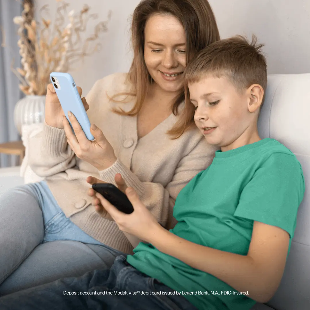 Mother and son looking at phones together on a couch